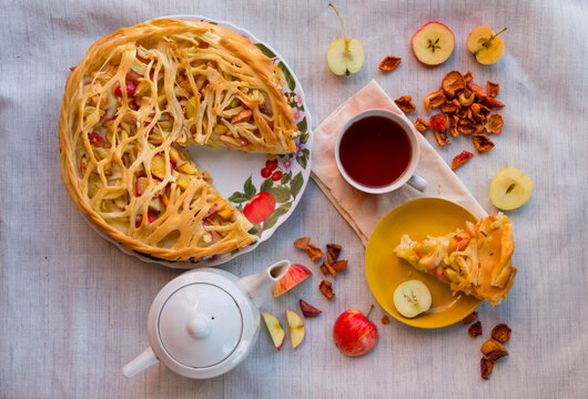 Overhead view of apple pie and drink served on table