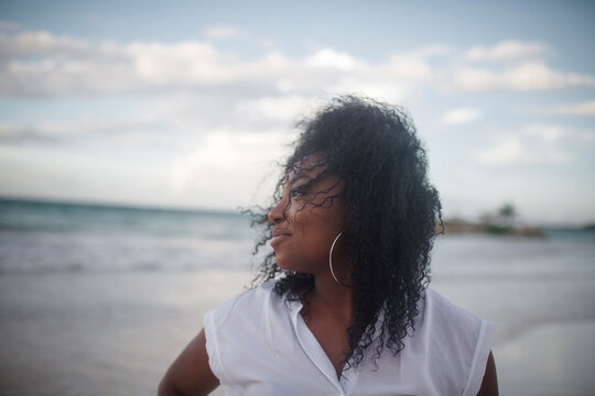 Thoughtful woman looking away at beach