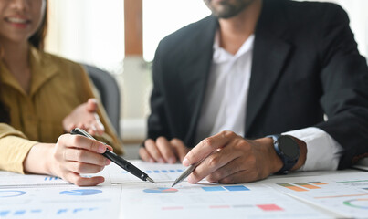 Two financial analyst discussing charts research reports growth and analyzing invest strategy at office.