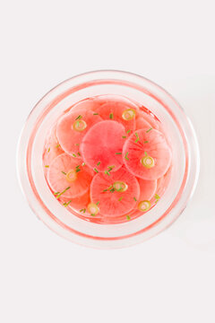 Overhead View Of Radishes In Bowl On White Background