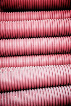 Close-up of red corrugated plastic pipes