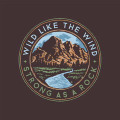 A logo for a rock mountain with a blue river called wild like the wind strong as a rock.