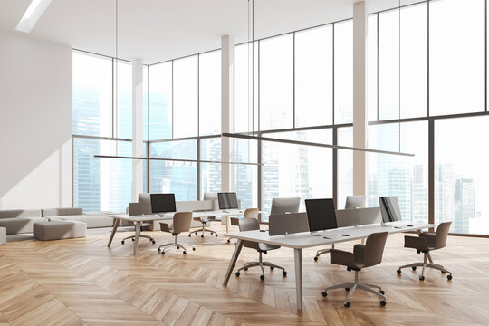 Panoramic white open space office with couch