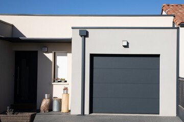 modern grey house with gray garage door portal of suburb new house - obrazy, fototapety, plakaty