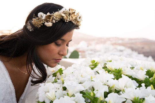lady smelling white flowers