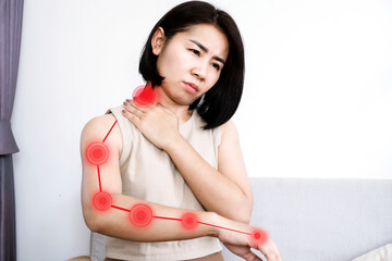 Asian woman suffering from nerve and muscle pain in neck and shoulder radiating down arm, Cervical Radiculopathy concept - obrazy, fototapety, plakaty