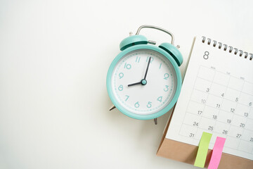close up of calendar and alarm clock on the white table background, planning for business meeting...