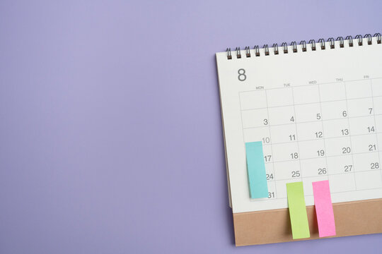 close up of calendar on the violet table background, planning for business meeting or travel planning concept