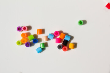 Pieces of colorful plastic beads isolated white background