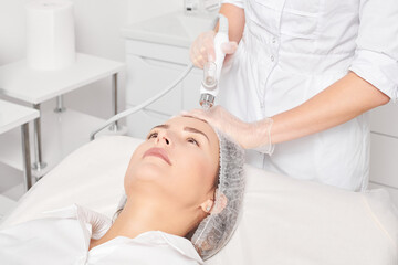 Beautician makes facial gas liquid oxygen serum epidermal peeling for rejuvenation woman face...
