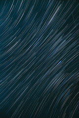 Meteors Trace On Night Dark Blue Sky Background. Spin Of Unusual Amazing Stars Effect In Sky. Abstract Bewitching Illusion Of Star Trails. Soft Colors.