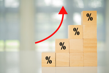 Interest rate rise concept. Wooden blocks with Icon percentage and arrow point up.