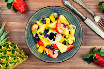 Pansy fruit salad with edible flowers.