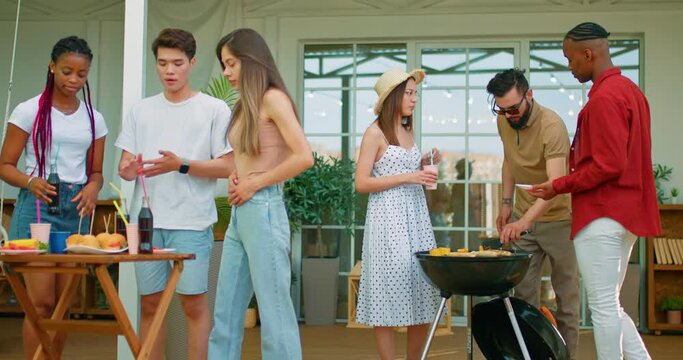 six multi ethic friends grilling barbecue drinking coke during party in garden, outdoors Spring, summer concept.business meeting. colleagues have rest friendship free spare time