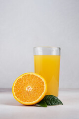 Glass of fresh juice and ripe orange