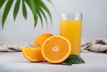 Glass of fresh juice and ripe orange