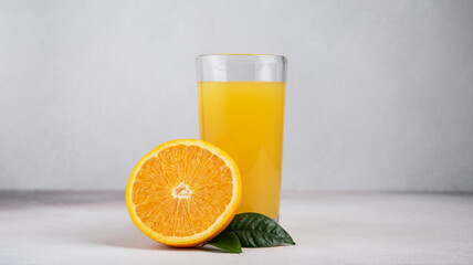 Glass of fresh juice and ripe orange