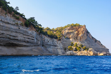 View of the rocky shore from the sea. Mediterranean Sea in Turkey. Popular tourist places. Background