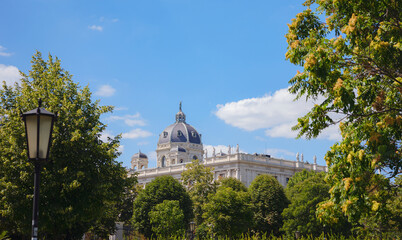 Summer Travel to capital of Austria Vienna. Museum of Art History or Kunsthistorisches Museum in Vienna. view through the greenery of the park
