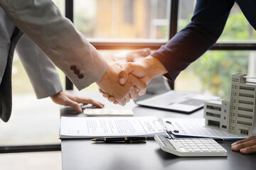 Close up shake hands, Considering buying a home, investing in real estate. Broker signs a sales agreement. agent, lease agreement, successful deal. - obrazy, fototapety, plakaty