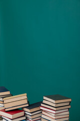many books stacked on a table on a green background in the science knowledge library