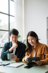Working on their finances together, Young couple asian working on their finances at home.