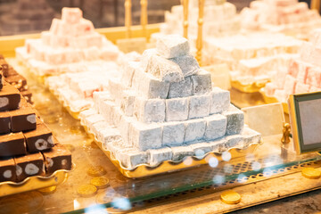 Mint Turkish delight and other types of Turkish delight a lot on shop window. Heap of sweet delicious rahat lokum dessert, assorted Turkish delight.