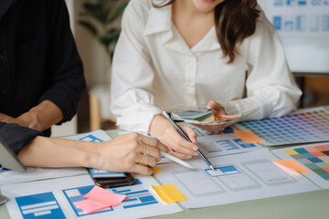 Creative digital development agency. developer team brainstorming on their project with laptop, smartphone.
