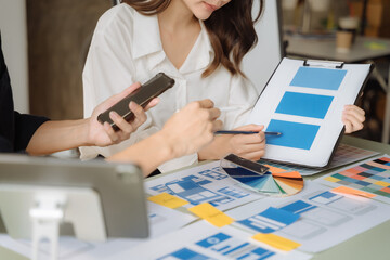 UI developer and ui designer brainstorming about mobile app interface wireframe design with...
