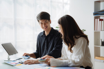 UI developer and ui designer brainstorming about mobile app interface wireframe design with customer breif and color code at office.