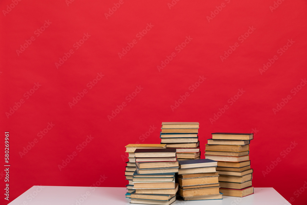 Wall mural knowledge science many books on a red background reading in the library in the office