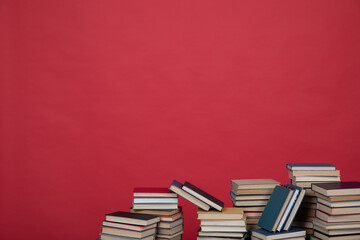knowledge science many books on a red background reading in the library in the office