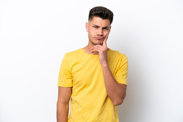 Fototapeta premium Young caucasian man isolated on white background and thinking