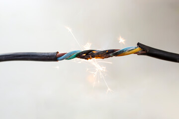 flame smoke and sparks on an electrical cable, fire hazard concept - obrazy, fototapety, plakaty