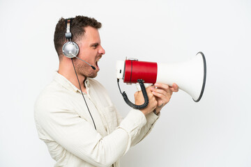 Telemarketer caucasian man working with a headset isolated on white background shouting through a megaphone