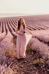 Fototapeta na wymiar Woman lavender field sunset. Romantic woman walks through the la