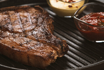pork steak with vegetables in a black iron pan