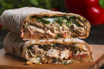 Shawarma sandwich fresh roll of, Grilled Meat and salad with white sauce on black background.