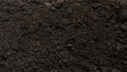 Textured brown earth surface as a background. Fertile soil. View from above. Organic composition of...