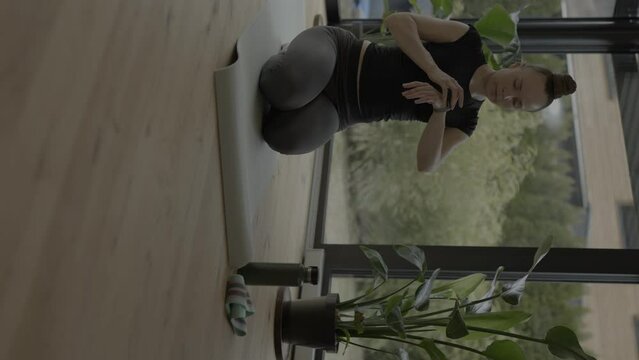 Caucasian woman is checking her fitness tracker.