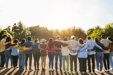 Group of multigenerational people hugging each others - Support, multiracial and diversity concept - Main focus on senior man with white hairs - obrazy, fototapety, plakaty