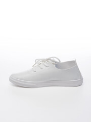 Leather sport shoes on a white background. Isolated white sneaker with shadow