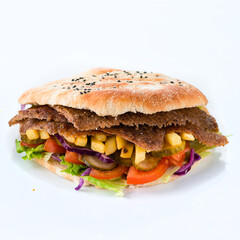 Flatbread with tomatoes, meat, lettuce, French fries, pickled cucumbers, cabbage on white background.