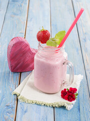 strawberry smoothie with yogurt on a wooden background.