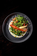 Fried salmon fish with creamy sauce, broccoli and salad