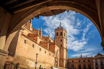 View of the Plaza de España in Lorca, Region of Murcia, Spain, from an arch with the Colegiata de San Patricio, a Renaissance-style national monument, in the background