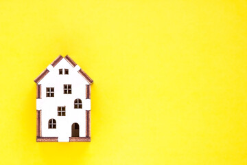 a small house on a yellow background. mortgage. credit. buying a home. realtor