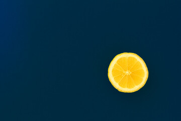 yellow lemon on a blue background with copyspace. Design, Fine Art, Minimalism