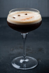 Espresso Martini Cocktail in a glass with coffee beans.