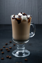 Hot coffee with cream and chocolate syrup in a mug.